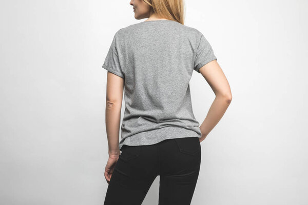 rear view of woman in blank grey t-shirt on white