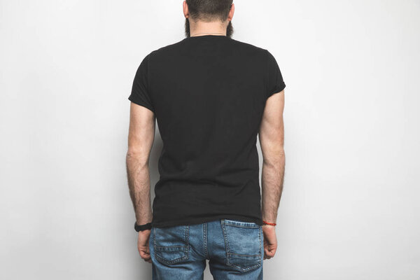 back view of man in black t-shirt isolated on white