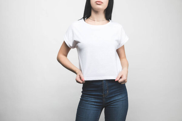 attractive young woman in blank t-shirt on white