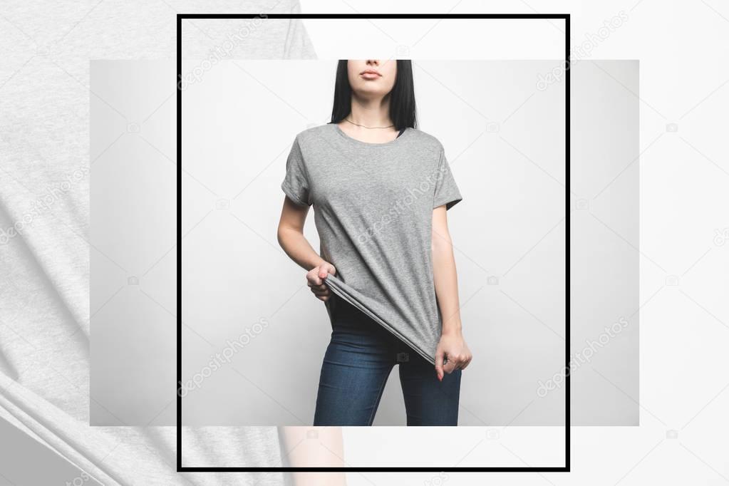 Stylish young woman in blank grey t-shirt on white with creative frame