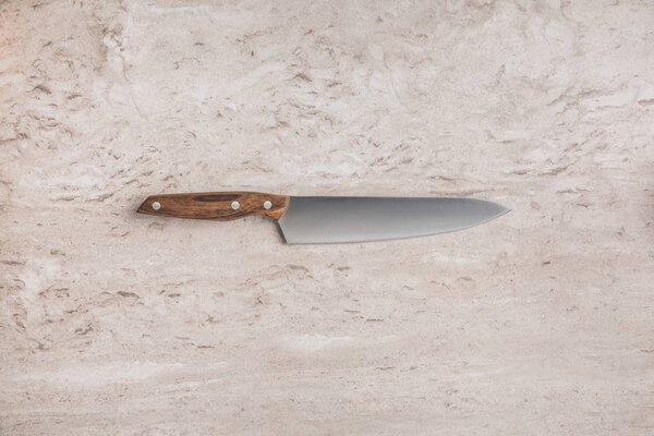 top view of one knife on marble surface