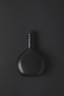 top view of empty bottle on black surface clipart