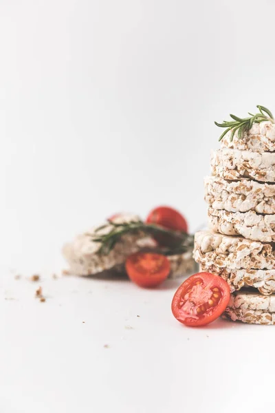 Close Shot Van Stapel Rijstwafels Met Rozemarijn Tomaten Wit Tafelblad — Stockfoto