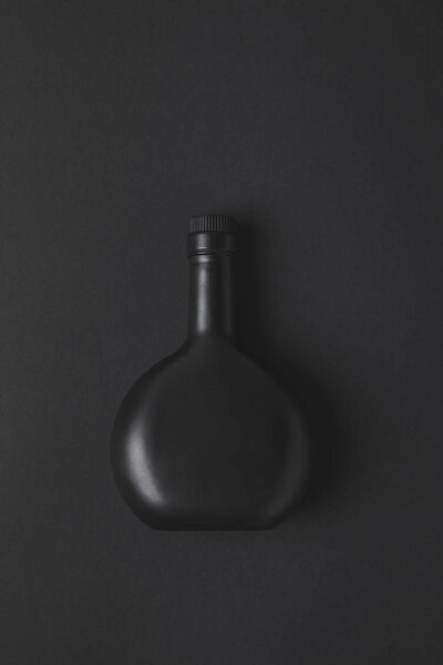 top view of empty bottle on black surface