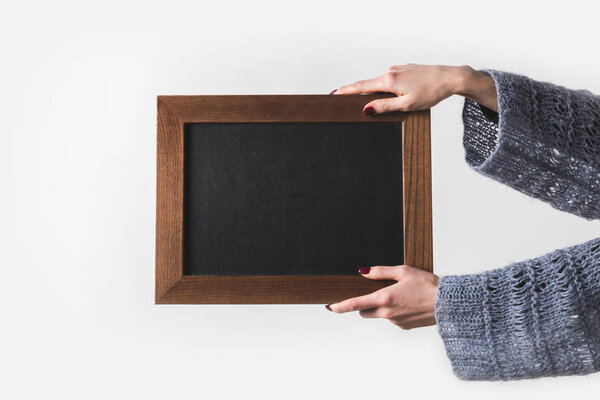 cropped image of man holding empty black board isolated on white