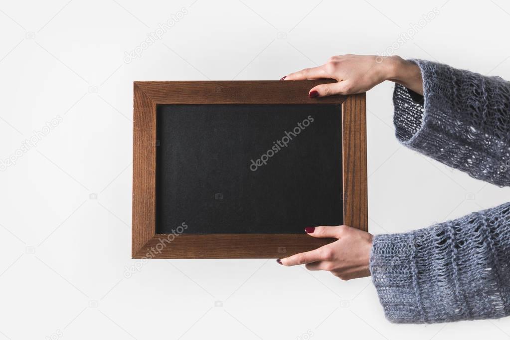 cropped image of man holding empty black board isolated on white
