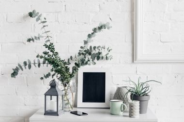 houseplants with blank chalkboard in front of white brick wall, mockup concept clipart