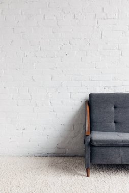 cropped shot of couch in living room with white brick wall, mockup concept clipart