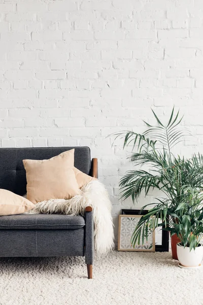 Comfy couch with flowerpots in white living room interior with brick wall, mockup concept — Stock Image Comfy Couch Flowerpots White Living Room Interior Brick Wall Mockup Royalty Free Stock Photos