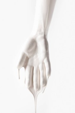 cropped image of female arm in white dripping paint isolated on white clipart