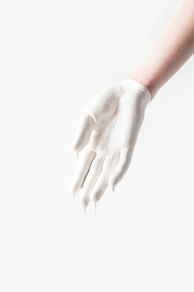 cropped image of woman in white paint in shape of glove isolated on white