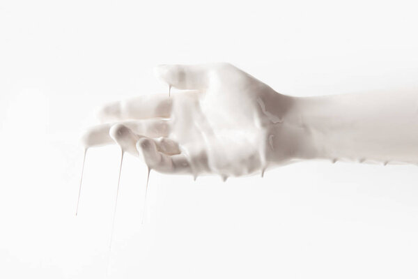 cropped image of female hand in white paint isolated on white