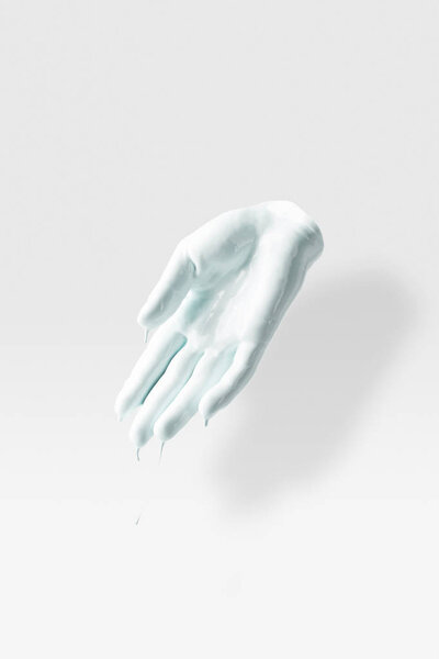 sculpture in shape of human arm in white paint on white