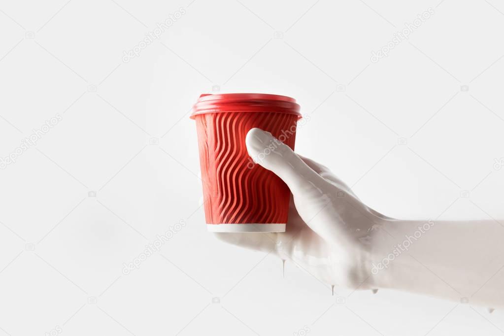 cropped image of woman in white paint holding red disposable coffee cup isolated on white