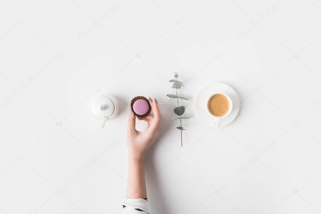 cropped shot of female hand and breakfast on white tabletop