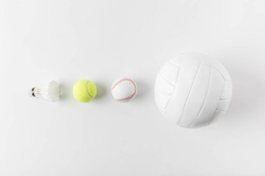 various sports equipment in row on white surface clipart