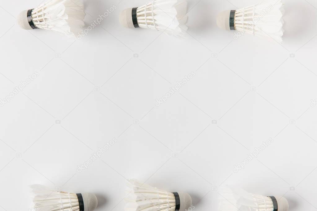 top view of frame made of badminton shuttlecocks on white surface