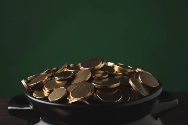 close up of golden coins in pot, st patricks day concept clipart
