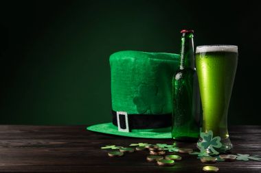 green hat with green beer and coins on wooden table, st patricks day concept clipart