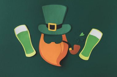 top view of paper decoration of leprechaun and beer for st patricks day isolated on green clipart
