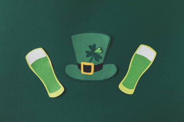 top view of paper decoration of green hat and beer for st patricks day isolated on green clipart