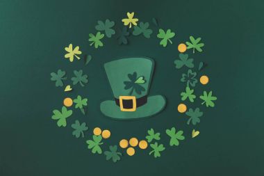 top view of paper decoration of green hat and shamrock for st patricks day isolated on green clipart