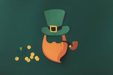 top view of paper decoration of leprechaun with smoking pipe for st patricks day isolated on green clipart
