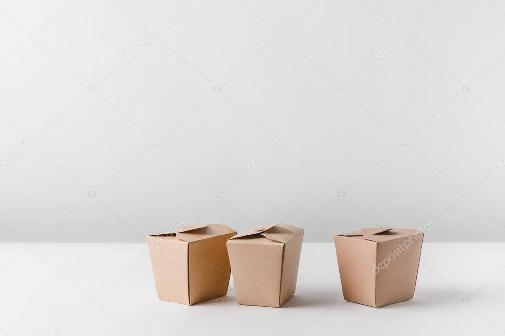 three noodles boxes on white surface
