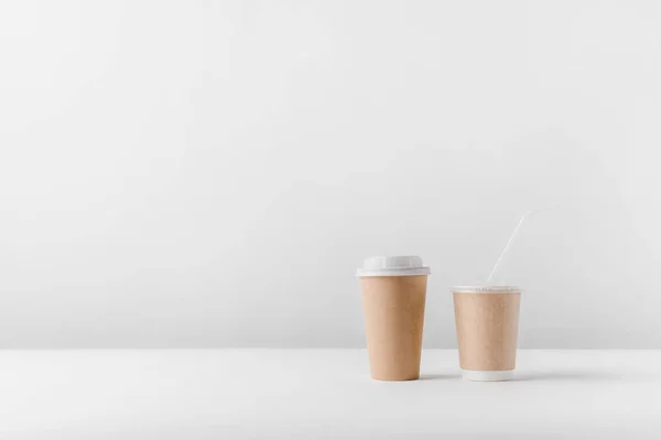 different coffee in paper cups on tabletop