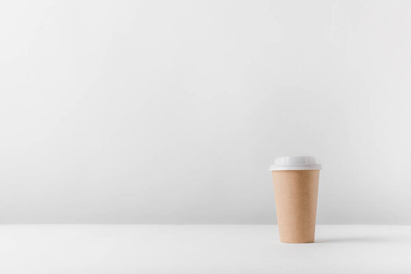 disposable coffee cup on white surface