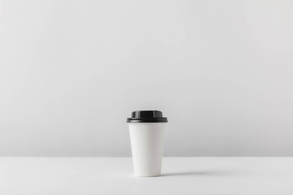 disposable coffee cup on white tabletop