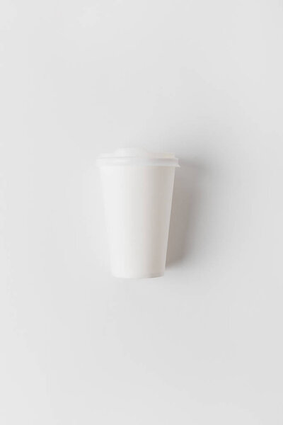 top view of coffee in paper cup on white