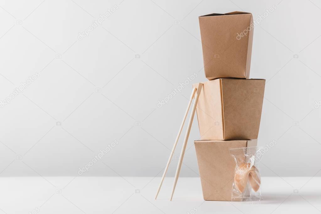 noodles boxes with chopsticks and chinese fortune cookie on tabletop