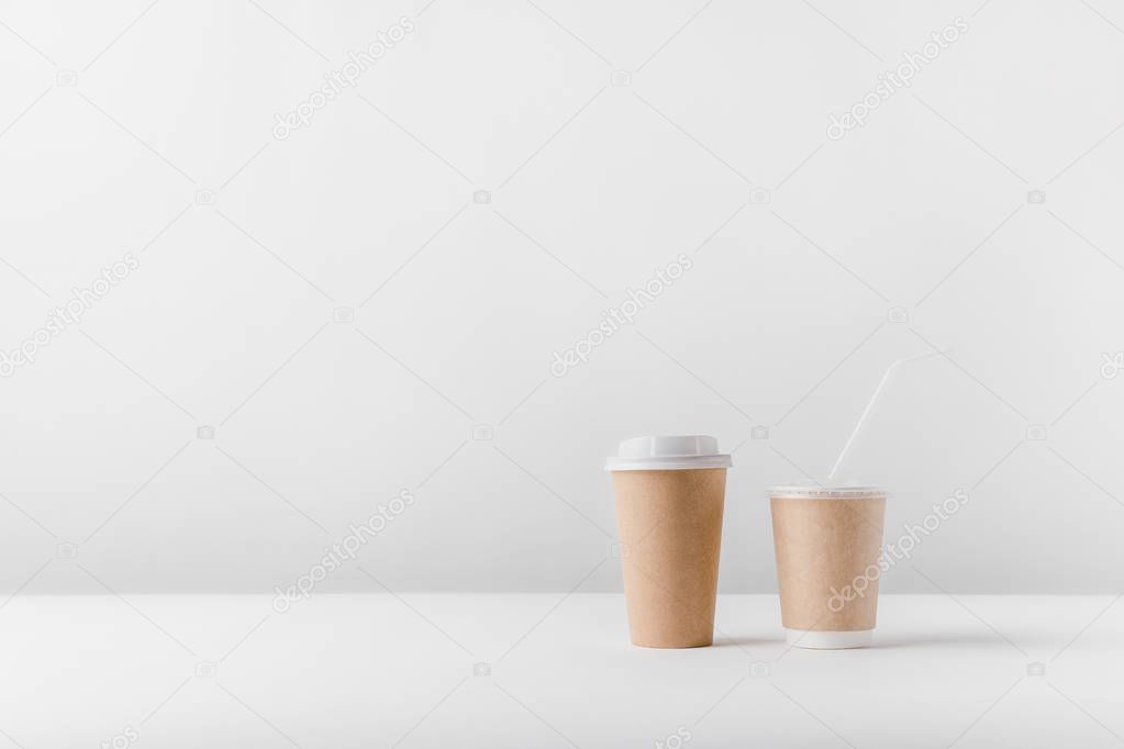 different coffee in paper cups on tabletop