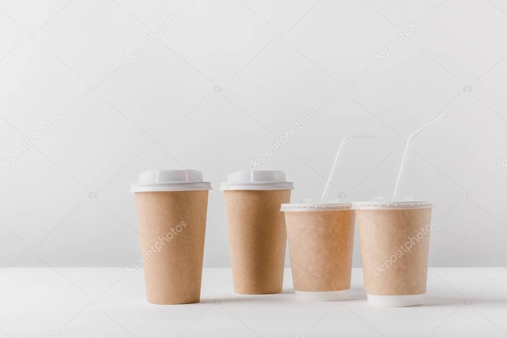 different coffee in paper cups on tabletop