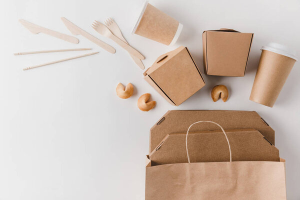 top view of junk food in take away boxes and chinese fortune cookies on white