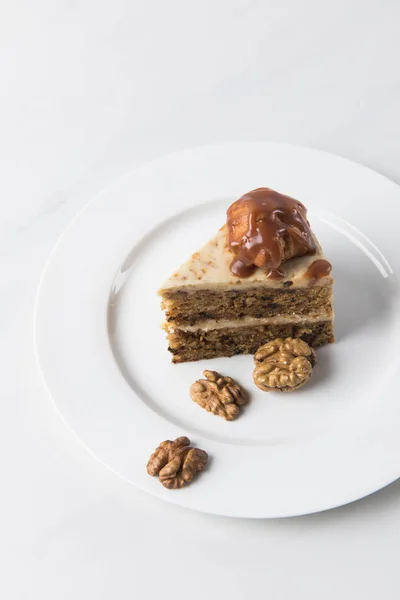 Cake White Plate Surrounding Walnuts Table — Free Stock Photo