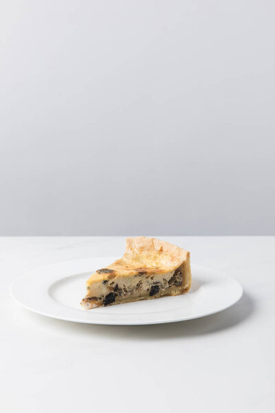 Closeup view of delicious pie on plate placed on white surface