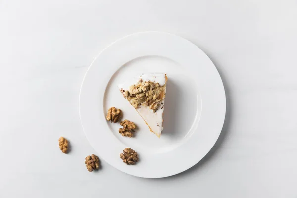 Plate Cake Surrounding Walnuts Placed White Surface — Stock Photo, Image