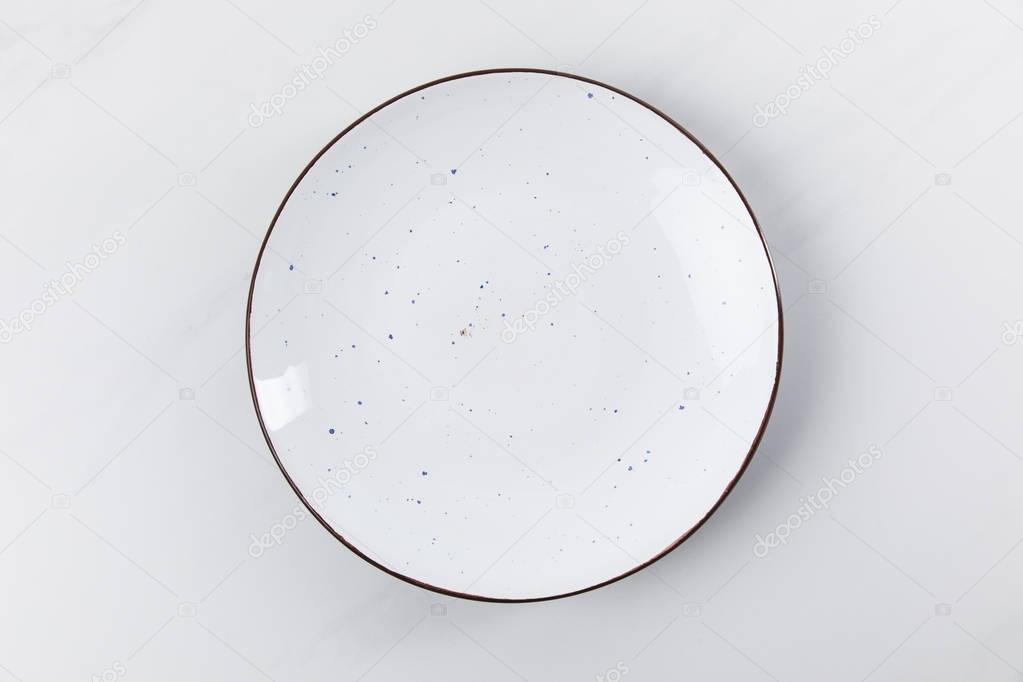 Top view image of plate placed on white surface, minimalistic conception