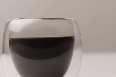 Close-up view of black coffee in cup on white background clipart