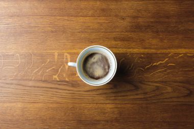 top view of cup of coffee on wooden table clipart