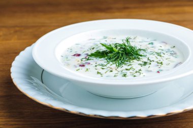 close-up view of delicious cold summer soup with yogurt and vegetables clipart
