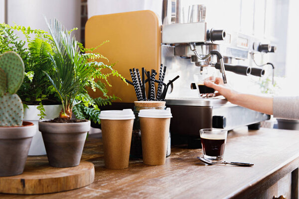 Close-up view of bartender preparing coffee on modern espresso machine
