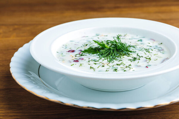 close-up view of delicious cold summer soup with yogurt and vegetables