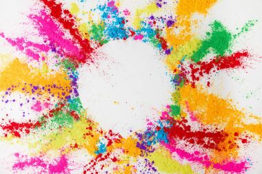 circle frame of multicolored traditional powder, isolated on white, holi festival