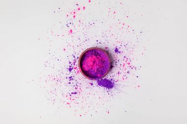 top view of purple and pink holi powder in bowl isolated on white clipart