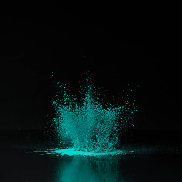 green holi powder explosion on black, Indian festival of colours