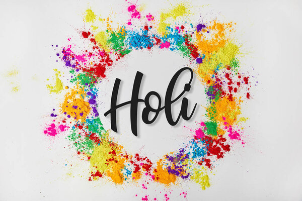 circle frame of colorful traditional paint with Holi sign, isolated on white, Hindu spring festival of colours