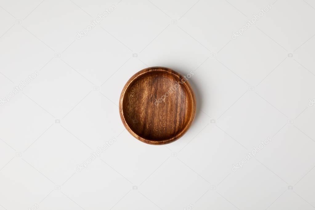 top view of wooden bowl isolated on white